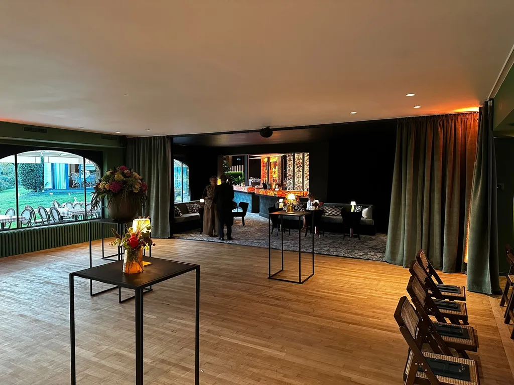 Tables hautes dans la salle du Barbizon, ouverte sur le jardin et le bar